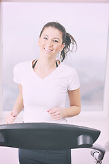 Image showing womanworkout  in fitness club on running track machine 