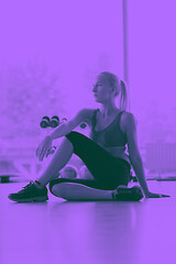 Image showing woman stretching and warming up for her training at a gym