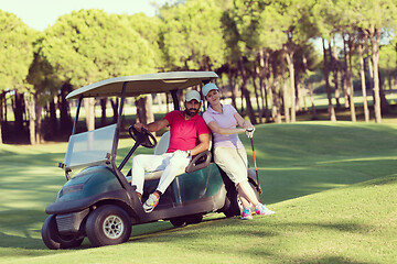 Image showing couple in buggy on golf course