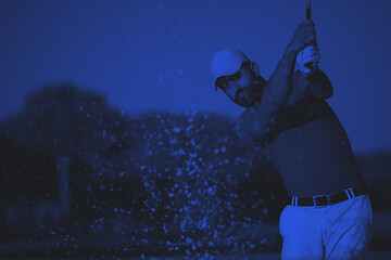 Image showing pro golfer hitting a sand bunker shot