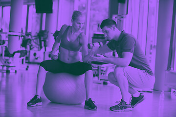 Image showing young sporty woman with trainer exercise weights lifting