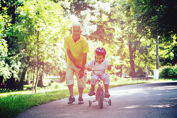 Image showing grandfather and child have fun  in park