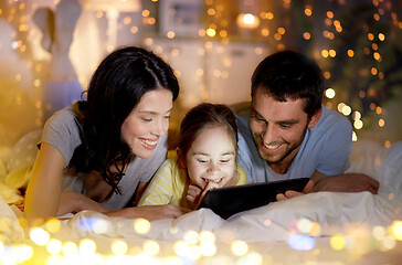 Image showing family with tablet pc in bed at night at home