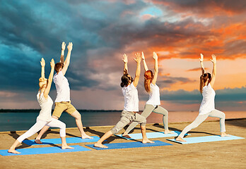 Image showing group of people making yoga exercises outdoors