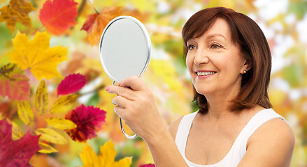 Image showing portrait of smiling senior woman with mirror