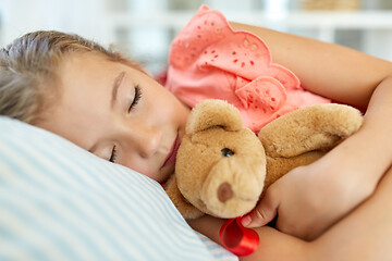 Image showing little girl sleeping with teddy bear toy at home