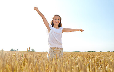 Image showing happy smiling young girl on cereal field in summer