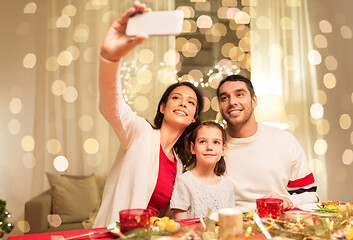 Image showing happy family taking selfie at christmas dinner