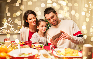 Image showing family with smartphone having christmas dinner