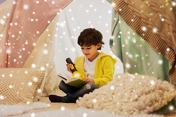 Image showing happy boy reading book in kids tent at home