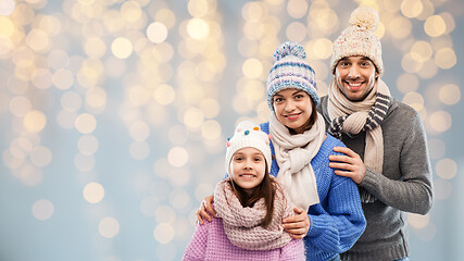 Image showing family in winter clothes over christmas lights