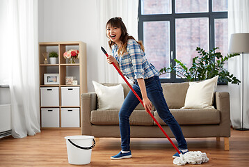 Image showing happy asian woman with mop cleaning floor at home