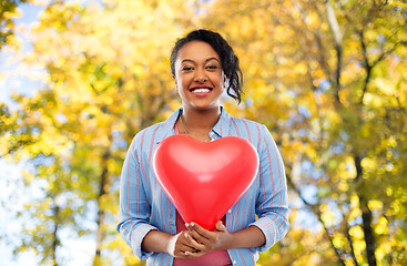 Image showing african american woman with heart-shaped balloon