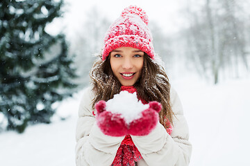 Image showing portrait of young woman with snow in winter park