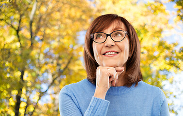 Image showing portrait of senior woman in glasses dreaming