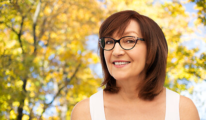 Image showing portrait of senior woman in glasses in autumn