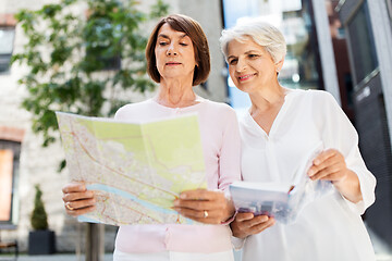 Image showing senior women with city guide and map on street