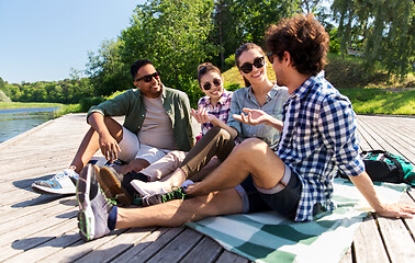 Image showing friends hanging out and talking outdoors in summer