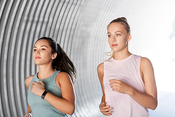 Image showing young women or female friends running outdoors