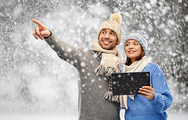 Image showing couple in winter clothes with tablet computer