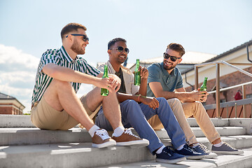 Image showing happy male friends drinking beer on street