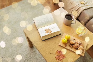 Image showing book, lemon, tea and cookies on table at home