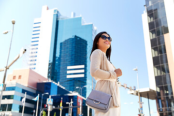 Image showing happy smiling young woman on city street