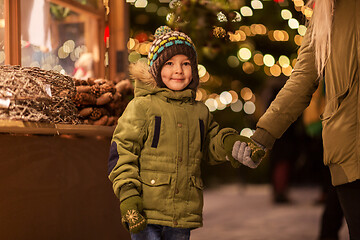 Image showing happy little boy with mother at christmas market