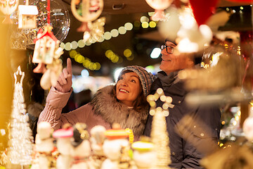 Image showing senior couple at christmas market souvenir shop