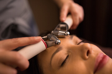 Image showing woman having hydradermie facial treatment in spa