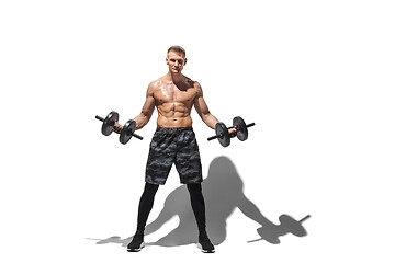 Image showing Beautiful young male athlete practicing on white studio background with shadows