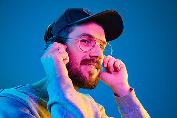 Image showing Enjoying his favorite music.