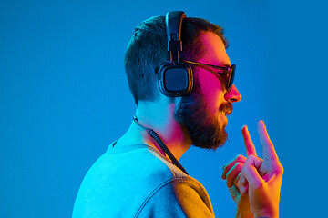 Image showing Enjoying his favorite music.