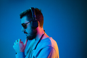 Image showing Enjoying his favorite music.