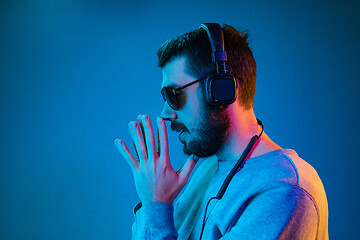 Image showing Enjoying his favorite music.