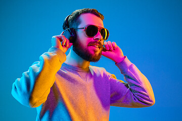 Image showing Enjoying his favorite music.