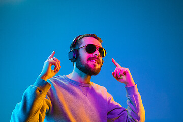 Image showing Enjoying his favorite music.