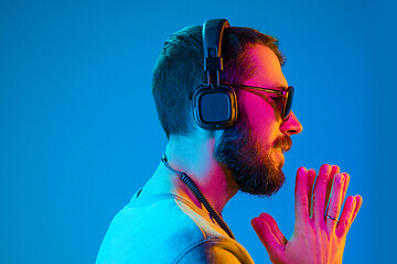 Image showing Enjoying his favorite music.