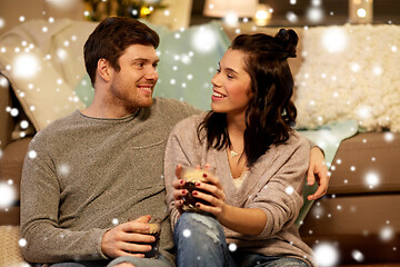 Image showing happy couple drinking coffee and eating at home