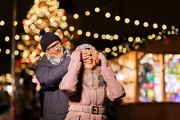 Image showing happy senior couple at christmas market