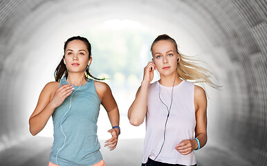 Image showing women or female friends with earphones running