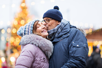 Image showing happy senior couple kissing at christmas market