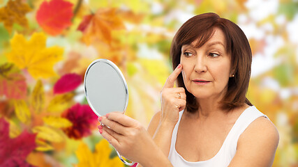 Image showing portrait of smiling senior woman with mirror