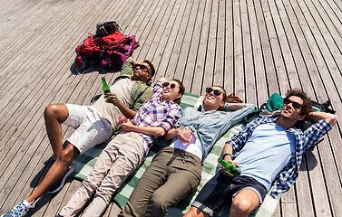 Image showing friends drinking beer and cider on wooden terrace