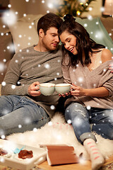 Image showing happy couple drinking hot chocolate on christmas