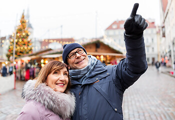 Image showing happy senior couple hugging at christmas market