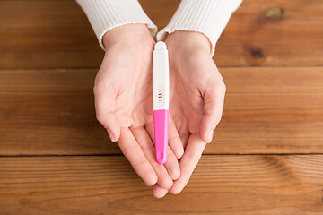 Image showing woman hands holding positive pregnancy test