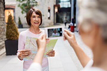 Image showing senior women with city map on street in tallinn