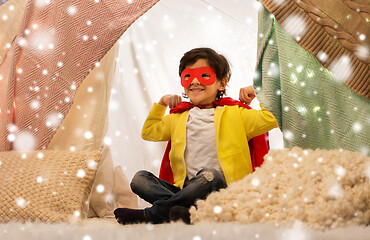 Image showing happy boy in super hero cape in kids tent at home