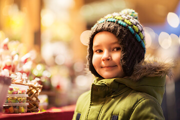 Image showing happy little boy at christmas market candy shop